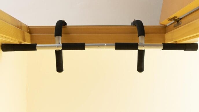 Bottom-up view of a pull-up bar installed in a doorway.