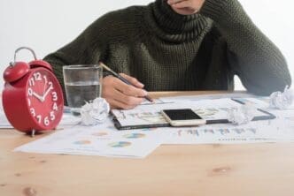 Close-up, top-down view of business people analyzing charts and graphs, illustrating business analysis and strategy.