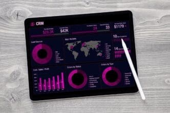 Tablet computer screen displaying charts and infographics from a business data analytics application.
