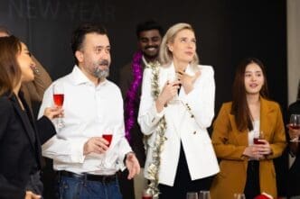 Diverse business people celebrating a success with dancing and applause at a party.