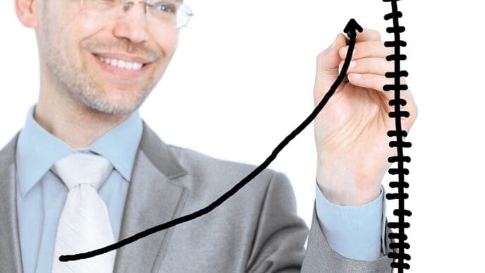 A businessman draws a graph on a white background.