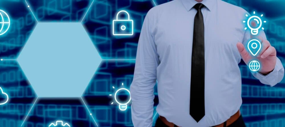 A businessman points to a digital screen displaying data and symbols in a futuristic pattern.