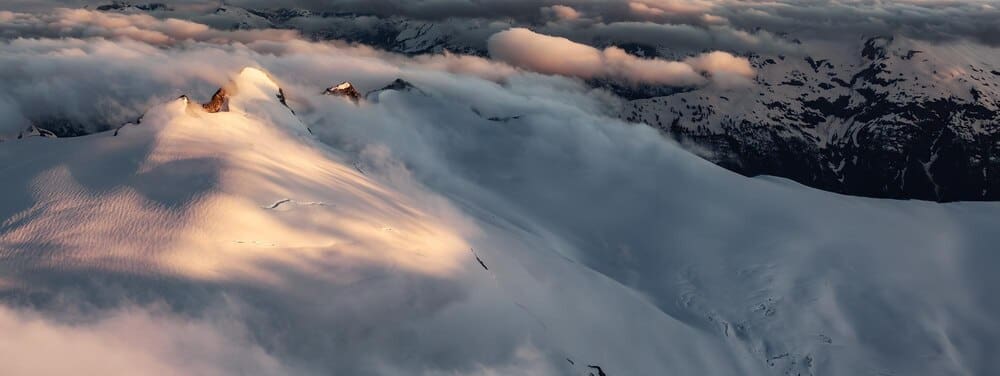 Aerial panoramic view of a Canadian mountain landscape at sunset.