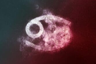 White and red abstract graphic of the Cancer zodiac sign against a dark night sky background.