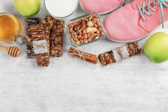 A table displays an assortment of cereal energy bars and nuts.