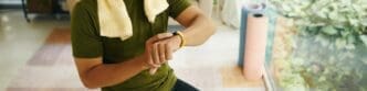 A person looks at a fitness tracker on their wrist after a workout.