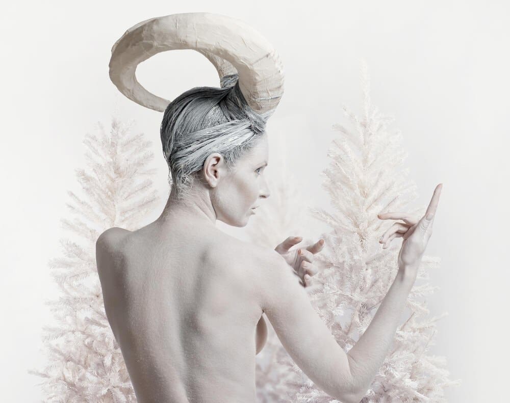 Close-up of a shirtless man against a plain white background.