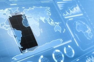 Close-up of a smartphone displays glowing digital business charts and a map interface against a blurry background, suggesting military control and espionage.