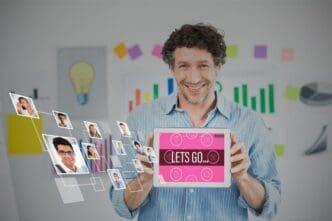 Businessman in a creative office holds a digital tablet with a blank screen.