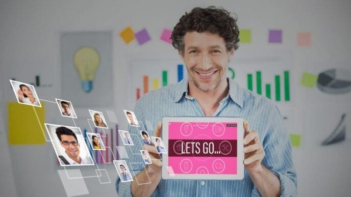 Businessman in a creative office holds a digital tablet with a blank screen.