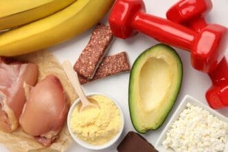 Overhead view of a white surface with arranged sports nutrition products, suggesting a concept.