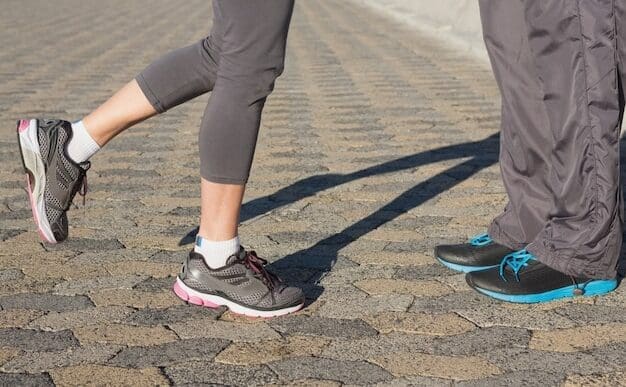 Two people in running shoes face each other.