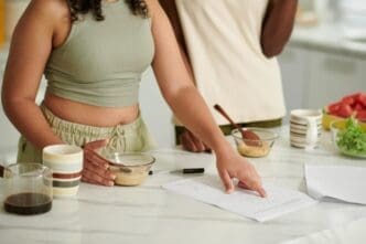 Students eating breakfast and studying, likely preparing for exams.
