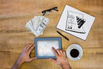 A hand-drawn doodle of data analysis symbols is superimposed over a background of stock market charts.
