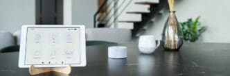 Tablet screen displaying a smart home control interface with various icons and settings.