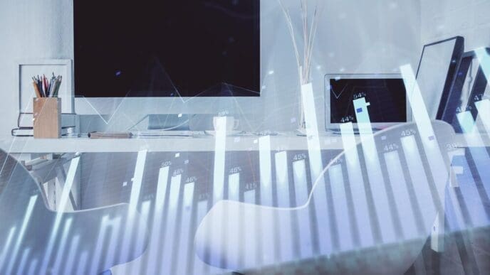 Double exposure of a stock market graph overlaid on an office interior, illustrating financial analysis.