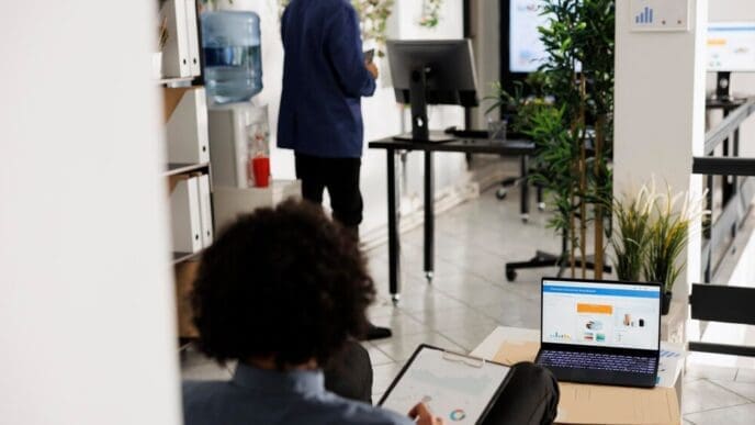 An entrepreneur analyzes financial reports, profit, sales, and investment data on a laptop screen.