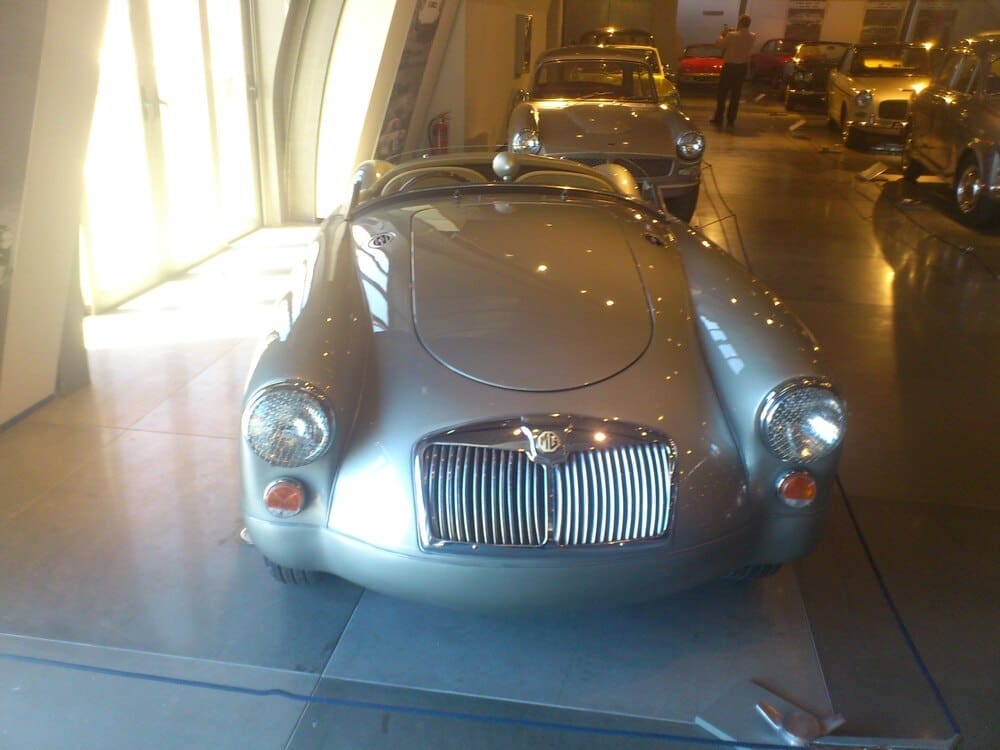 An exhibit showcases a collection of classic automobiles.