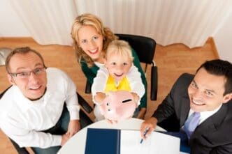 A family sits at a table with a financial consultant, discussing finance and insurance options.