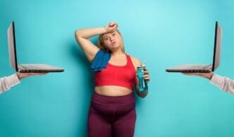 A plus-size woman with a tired expression works out at home using a laptop.