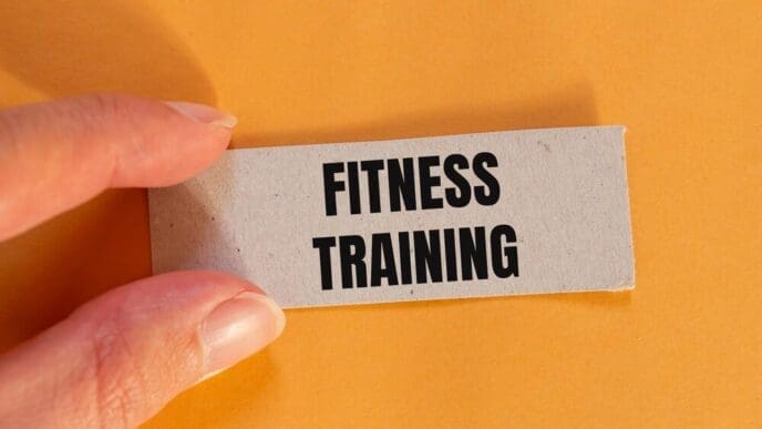 Ripped paper with a fitness training message is set against an orange background with copy space.