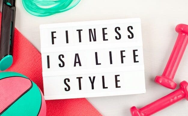 Flat lay of a dumbbell, water bottle, and other exercise equipment.