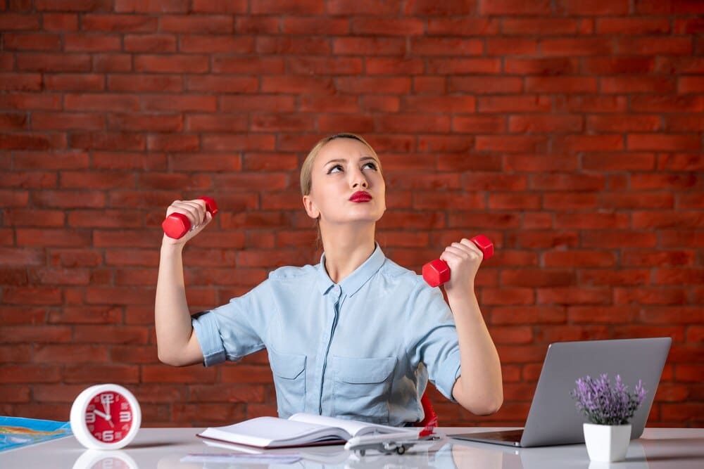 A professional travel agent in athletic wear works out with red dumbbells, assisted by a map.