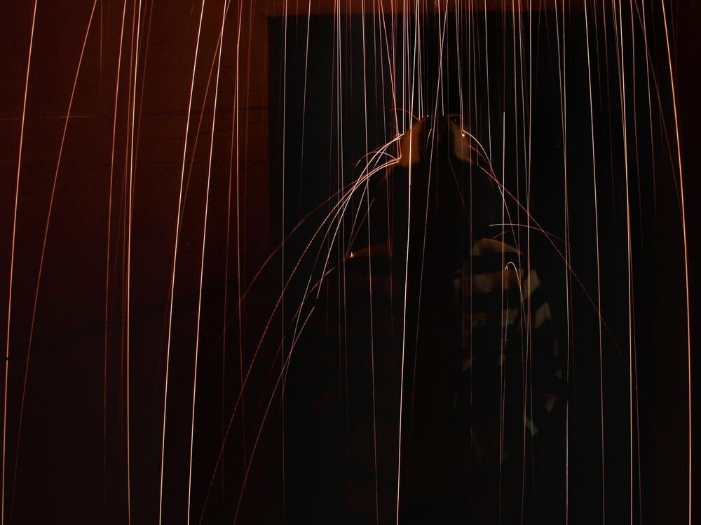 Sparks illuminate the dark night sky.