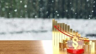 A gold dollar coin sits inside a crystal ball with a gift box, representing a business or holiday concept.