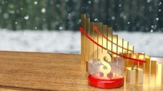 A gold dollar coin rests inside a clear crystal ball with a gift box, symbolizing a business or holiday concept.