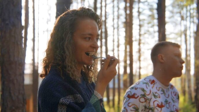 A group of friends enjoys grilled vegetables together outdoors.