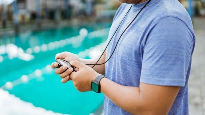 Hands of an instructor setting a stopwatch.
