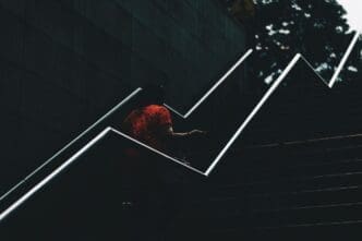 High-angle shot of a bird perched on a railing.