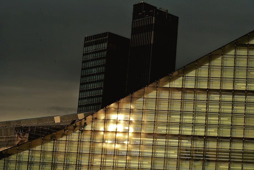 High-rise office buildings stand tall against a blue sky.
