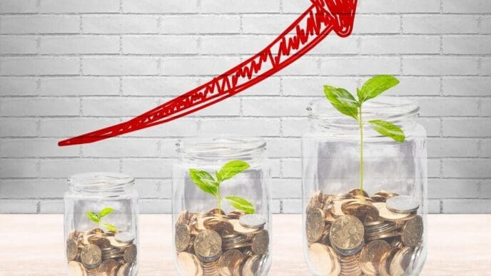 Glass jars filled with coins and small saplings are arranged in a line.