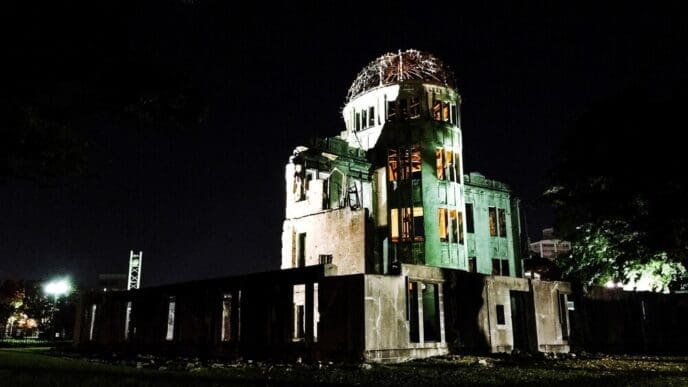Low-angle view of an illuminated building against a dark night sky in Hiroshima.