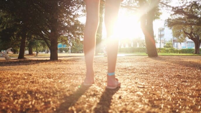 Low-angle view of a woman standing in a park.