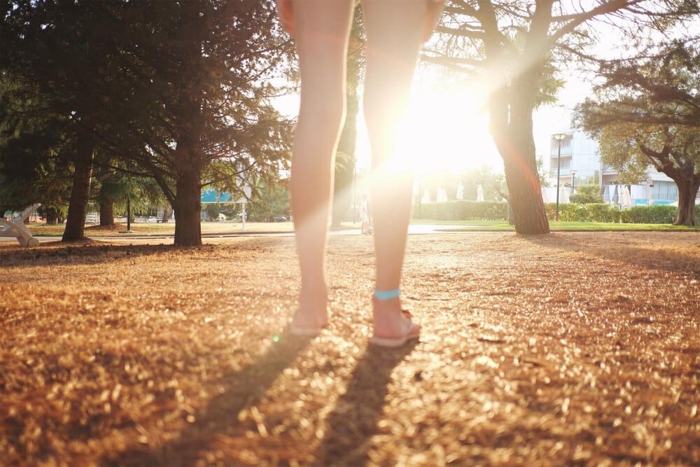 Low-angle view of a woman standing in a park.