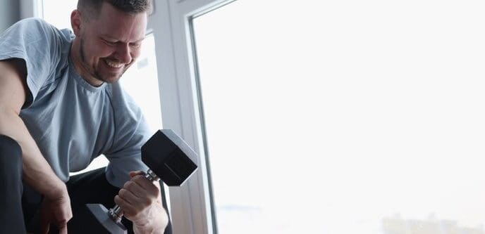 Man performing bicep curls with dumbbells.