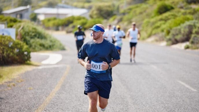 A man participates in an outdoor triathlon, running a street race as part of the competition.