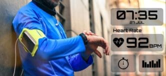 A man runs through a park while wearing a smartwatch.