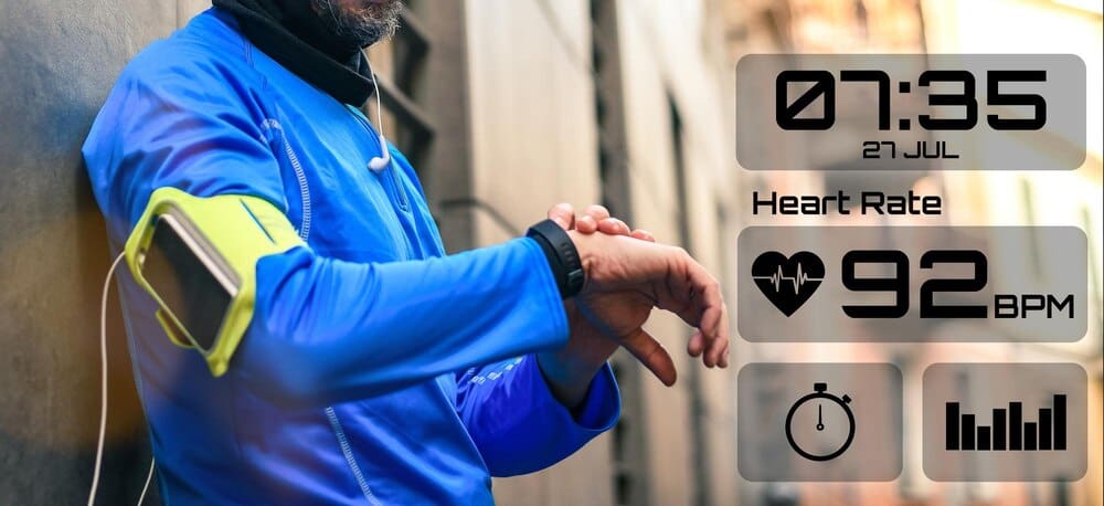 A man runs through a park while wearing a smartwatch.