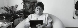 An elderly businesswoman uses a tablet.