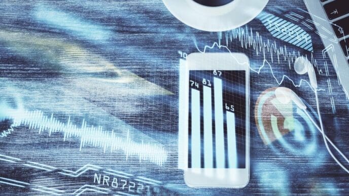 A top-down view shows a table with a phone and overlaid with a multi-exposure drawing of technology-related themes.