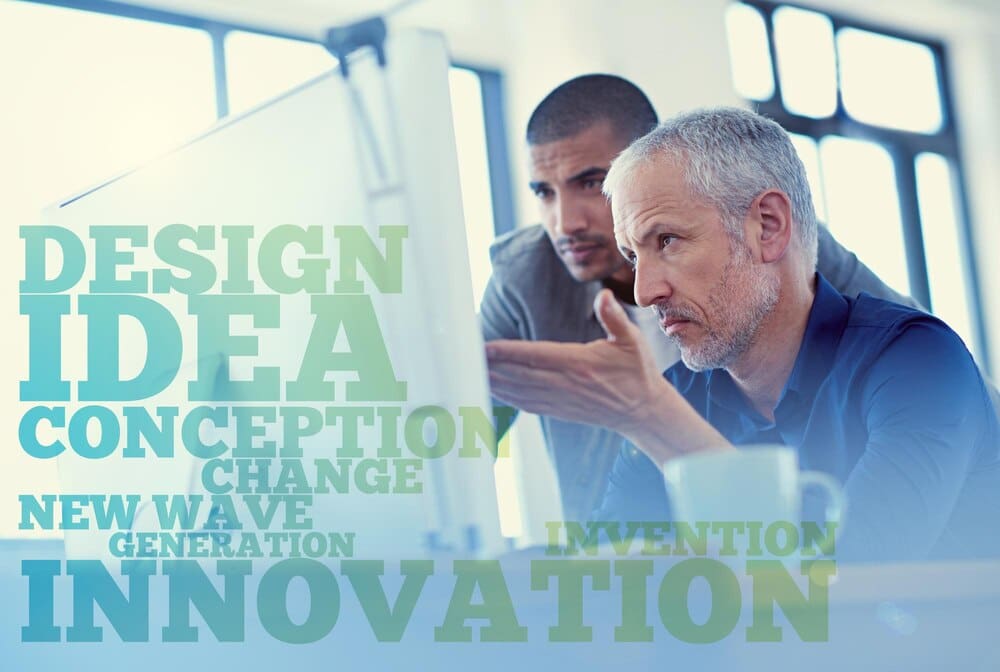 A word cloud related to office work overlays a photo of business people collaborating on a web design project.