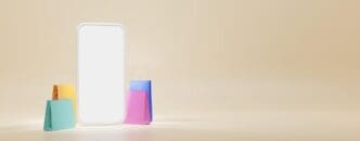 A smartphone displays a blank screen surrounded by colorful gift bags on a beige background, representing an online shopping and loyalty program concept.