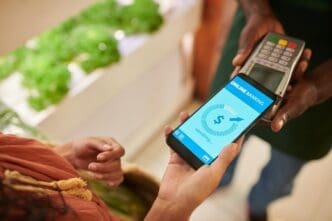 A person uses a mobile phone to pay for purchases at a store.