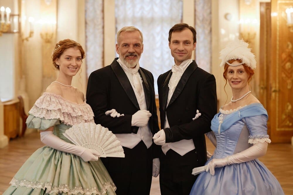 People dressed in historical costumes pose for a photograph.
