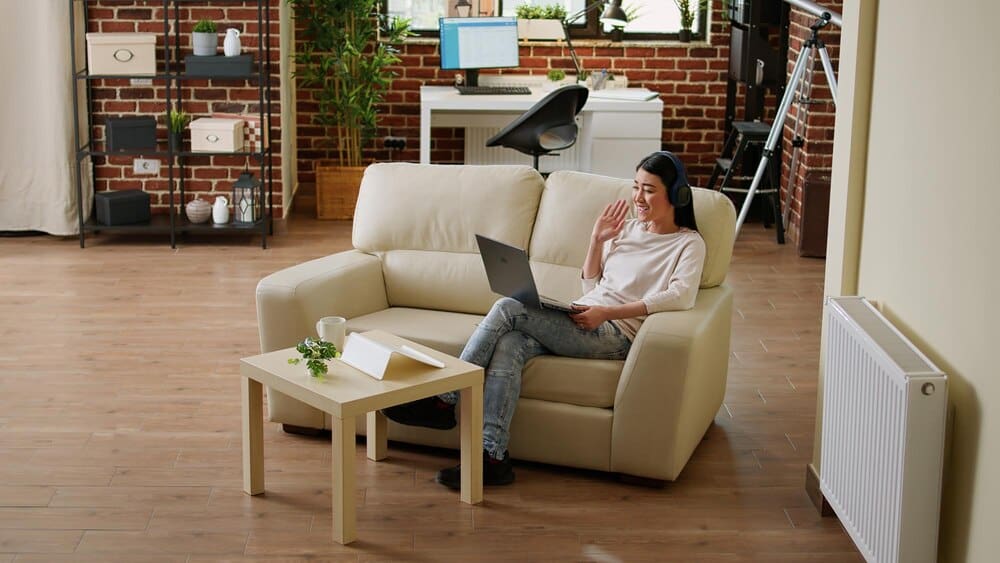 A woman sits in a chair indoors.