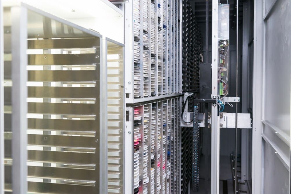 Workers in a clean room assemble electronic components on a production line in a high-tech factory.
